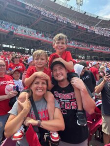Kyle Wilson (right) with his family at a Cincinnati Reds baseball game.